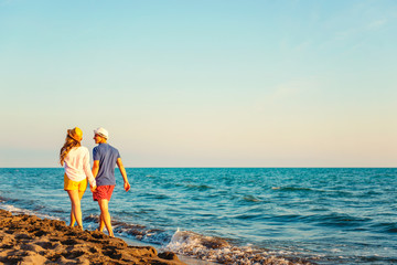 Fototapeta na wymiar Happy Romantic Middle Aged Couple Enjoying Beautiful Sunset Walk on the Beach. Travel Vacation Retirement Lifestyle Concept