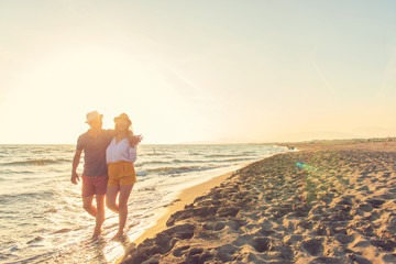 Happy Romantic Middle Aged Couple Enjoying Beautiful Sunset Walk on the Beach. Travel Vacation...