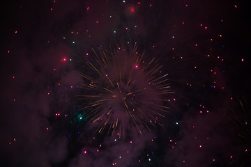 Explosive and colorful holiday fireworks at night sky.