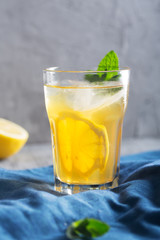 Glass of refreshing homemade lemonade with ice and mint