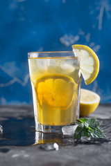 Glass of refreshing homemade lemonade with ice and mint