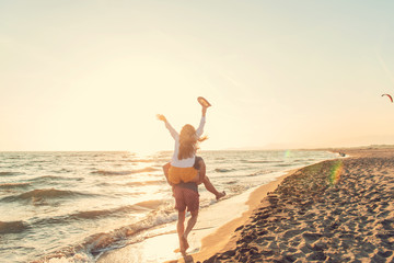 Happy Romantic Middle Aged Couple Enjoying Beautiful Sunset Walk on the Beach. Travel Vacation Retirement Lifestyle Concept