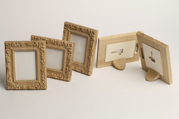 rotary miniature wooden frames cut for photographs or paintings, photographed on a white background