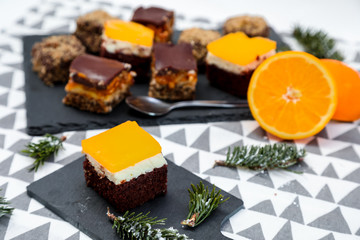 Homemade cake with caramel and oranges on a funcky background.