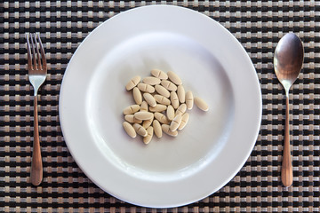 In a white plate, there are several supplements.