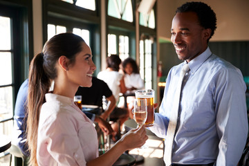 Two Businesswomen Meeting For After Works Drinks In Bar