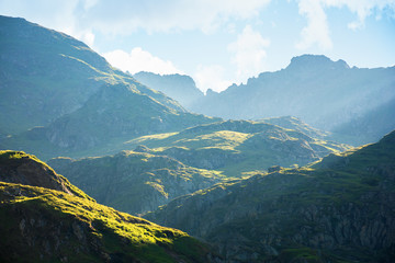 fagaras mountain ridge in the morning. rocky formations in sunlight. beautiful summer scenery