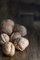 Walnuts on dark wood background with copy space