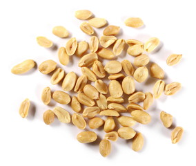 Salted and fried, roasted peanuts, pile isolated on white background, top view