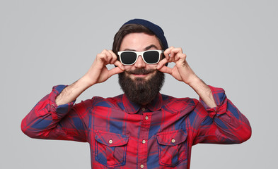 Bright playful man curling mustache 