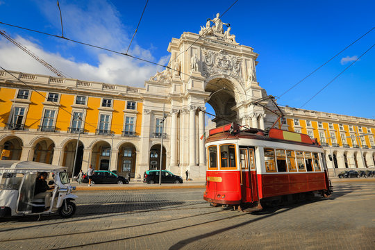 Touristic tram at Praca do Comercio (Commercial Square) near Triumphal Arch of Rua Augusta. Sunny day in famous tourist place of Lisboa