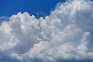 Naklejka na ściany i meble Big beautiful white cumulus cloud on a blue sky
