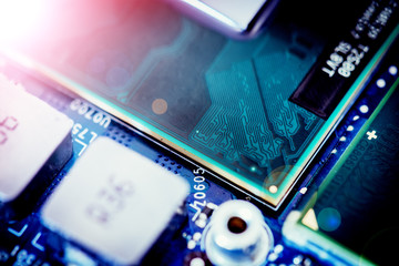 Computer Technology: Close up of a computer chip on a circuit board. Light effect.