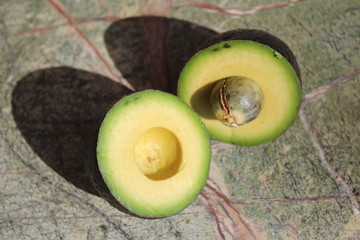 Two pieces of avocado. Avocado cut into two parts