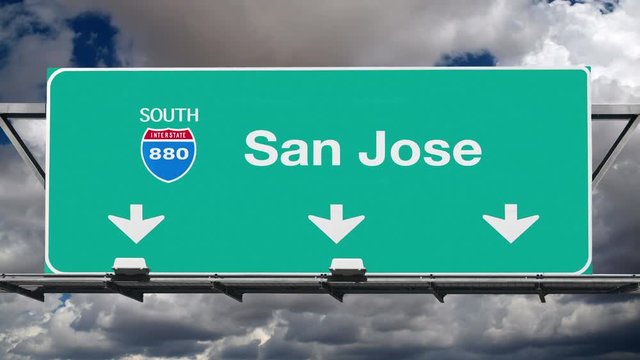 San Jose California interstate route 880 overhead freeway directional arrow sign with time lapse clouds.