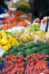 Strawberry, avocado, lemon, banana, tomato at market place