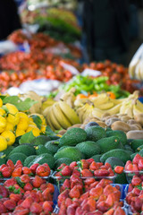 Strawberry, avocado, lemon, banana, tomato at market place