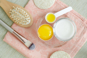 Greek yogurt (sour cream or kefir), raw egg and olive oil - ingredients for preparing diy face and hair masks, scrubs and moisturizers. Homemade beauty treatments recipe. Top view, copy space