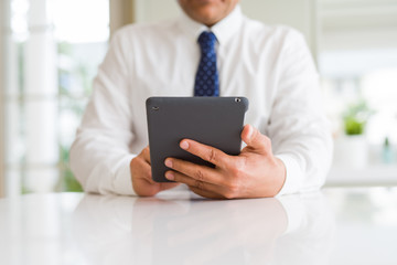 Close up of middle age business man using tablet