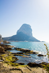 Ancient roman ruins, Banos de la Reina, the Baths of the Queen in Calpe beach, Spain. The Penon of Ifach mountain is in the background