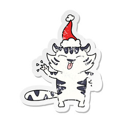 distressed sticker cartoon of a white tiger wearing santa hat