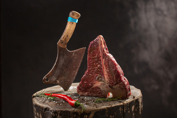 Raw Fresh Marbled Meat Beef ax on a black background.