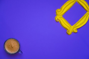 Purple background yellow frame notebook pen coffee mug globe flower flat lay instant photography camera keyboard computer 