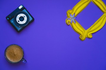 Purple background yellow frame notebook pen coffee mug globe flower flat lay instant photography camera keyboard computer 