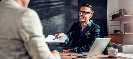 Businessman passing over contract to his client