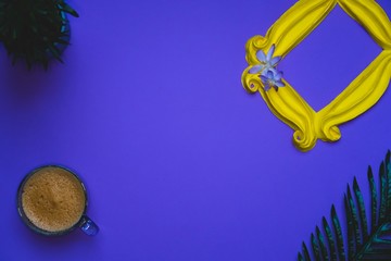 Purple background yellow frame notebook pen coffee mug globe flower flat lay instant photography camera keyboard computer 