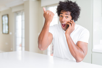 Fototapeta na wymiar African American business man talking on the phone annoyed and frustrated shouting with anger, crazy and yelling with raised hand, anger concept