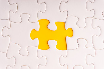 Obraz premium White jigsaw puzzle and missing pieces with selective focus and crop fragment