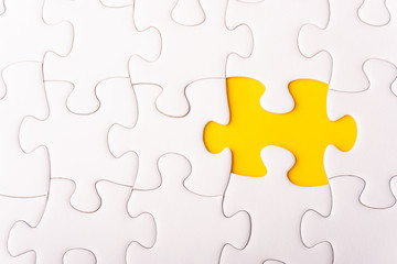 White jigsaw puzzle and missing pieces with selective focus and crop fragment