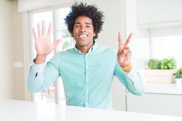 African American business man wearing elegant shirt showing and pointing up with fingers number...