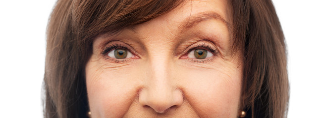 beauty, vision and old people concept - half of face of senior woman