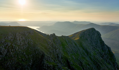 Sunset over Ennerdale Water from Scoat Fell with views of Steeple In the English Lake District, UK.