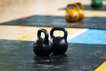Fototapeta na wymiar Two black metallic weights stand on sport mats