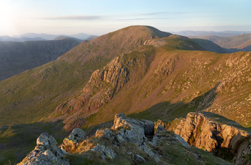 Sunset over Ennerdale from Scoat Fell with views of Pillar In the English Lake District, UK.