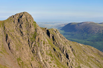 Sunrise over Ennerdale from Scoat Fell with views of Steeple In the English Lake District, UK.