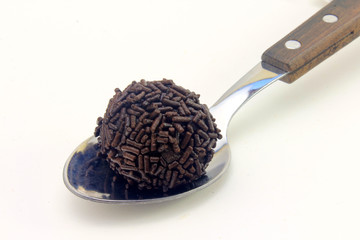 brigadeiro (brigadier), chocolate sweet typical of Brazilian cuisine covered with particles, in a white background
