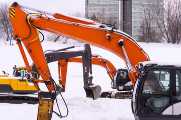 dance of excavators in the snow