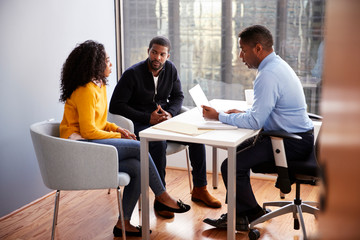 Couple Meeting With Male Financial Advisor Relationship Counsellor In Office