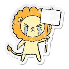 distressed sticker of a cartoon crying lion with placard