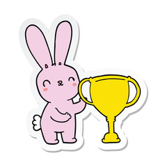 Fototapeta na wymiar sticker of a cute cartoon rabbit with sports trophy cup