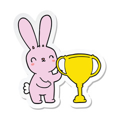 sticker of a cute cartoon rabbit with sports trophy cup