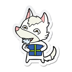 sticker of a cartoon hungry wolf holding christmas present