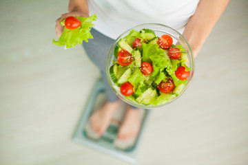 Diet and Healthy eating. Young woman eating healthy salad after workout