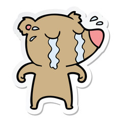sticker of a cartoon crying bear
