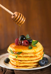 Stack of pancakes with fresh berries, close-up.