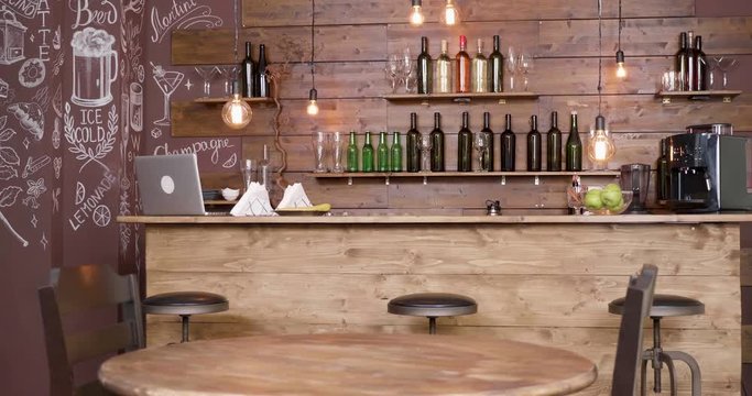 Smooth slide shot of an empty coffee shop interior. No people inside a cozy, vintage style bar and cafeteria.